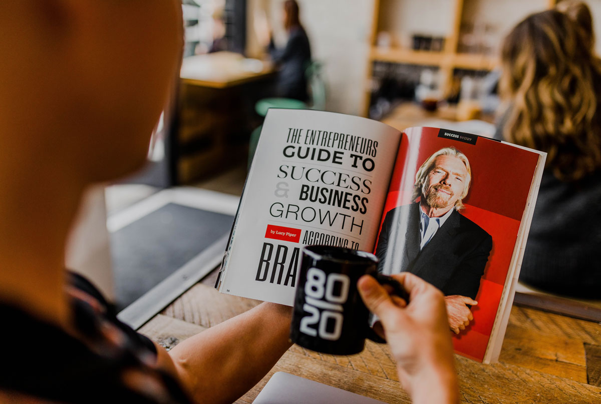 Person reads book about finding business success